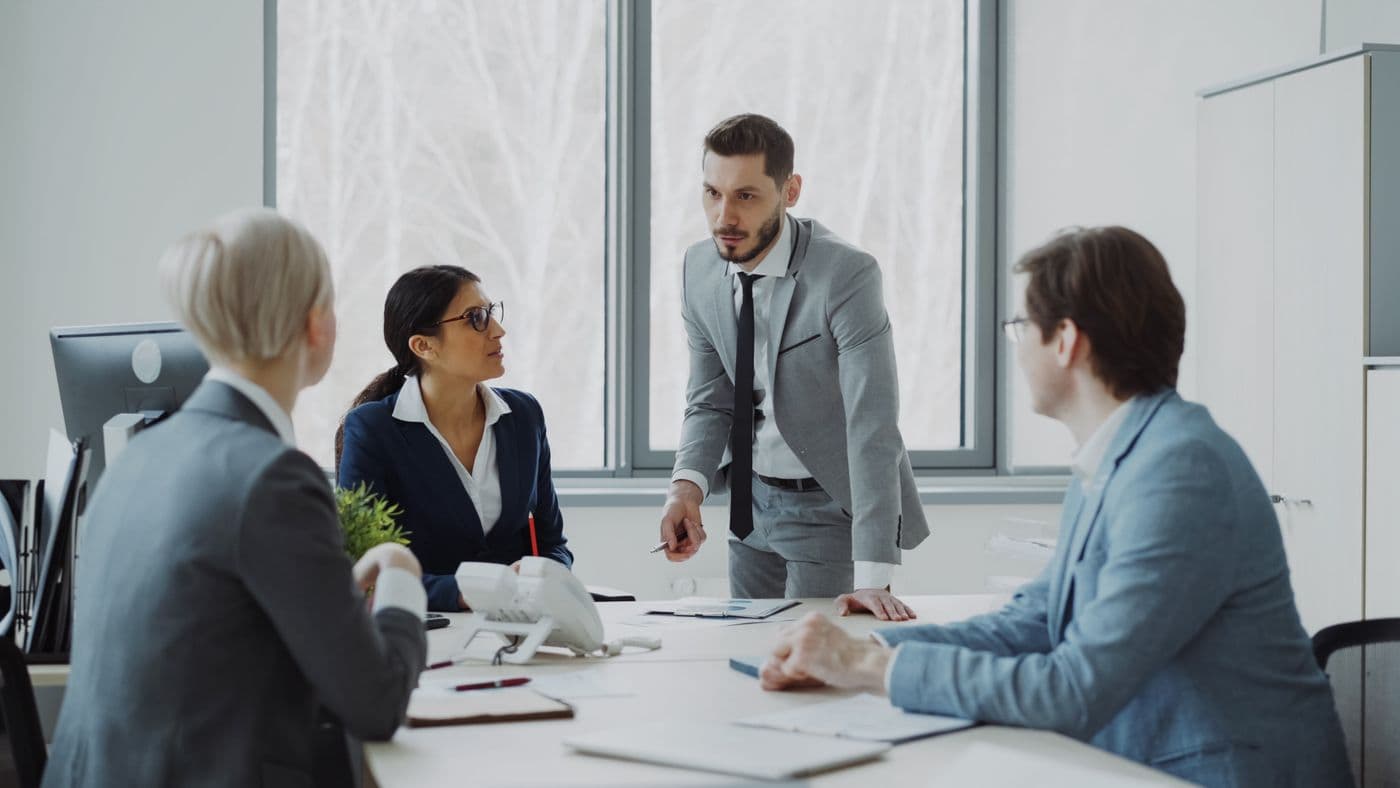 A leadership team strategizing together in a bright meeting room