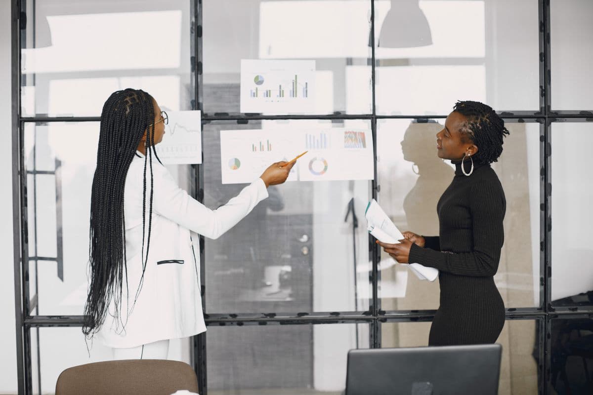 Two colleagues reviewing performance charts together