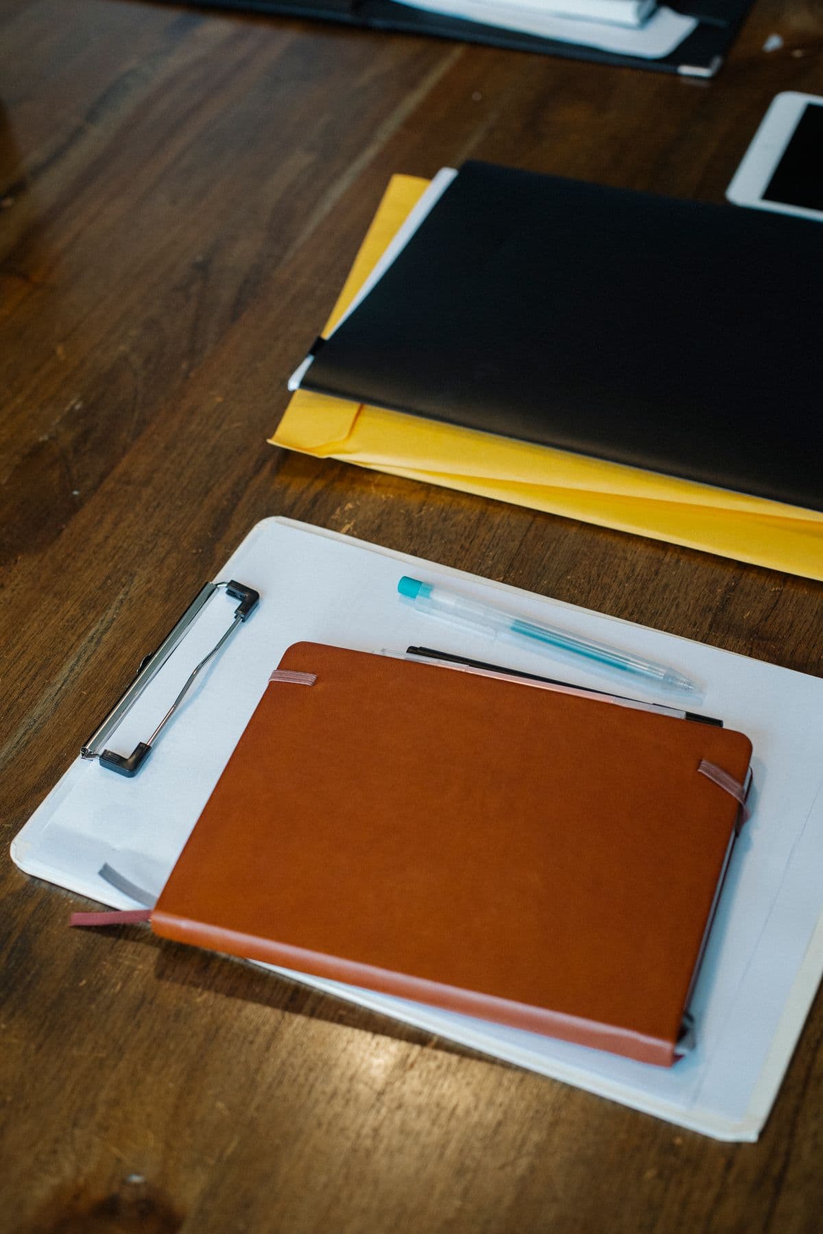 A clipboard and notebook laid out on a desk, ready for a self-assessment